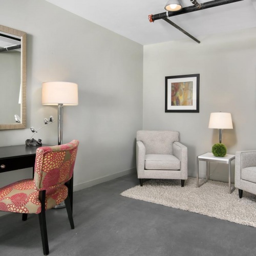 a room with a table chairs and a mirror