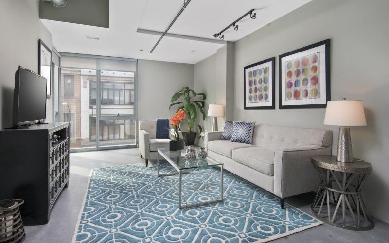 a living room with a blue rug